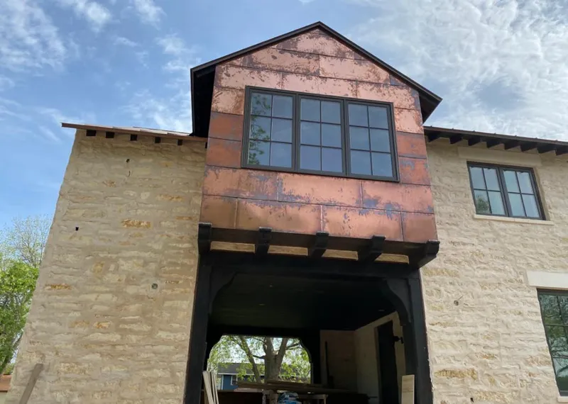 Copper metal panel facade on a stone building for Skylight Installation in Suffield